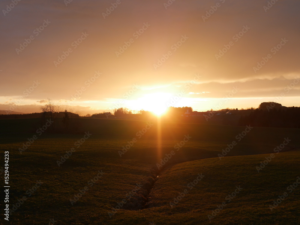 Beautiful sunset over a field with a river running through it Beautiful sunset over a field with a river running through it