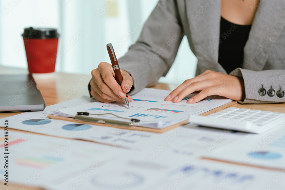 Businessman analyzing financial charts and documents at office desk, focused on planning, investment, accounting, growth strategy, and corporate success Businessman analyzing financial charts and documents at office desk, focused on planning, investment, accounting, growth strategy, and corporate success