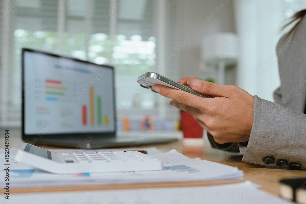 Fototapeta premium Businessman analyzing financial charts and documents at office desk, focused on planning, investment, accounting, growth strategy, and corporate success