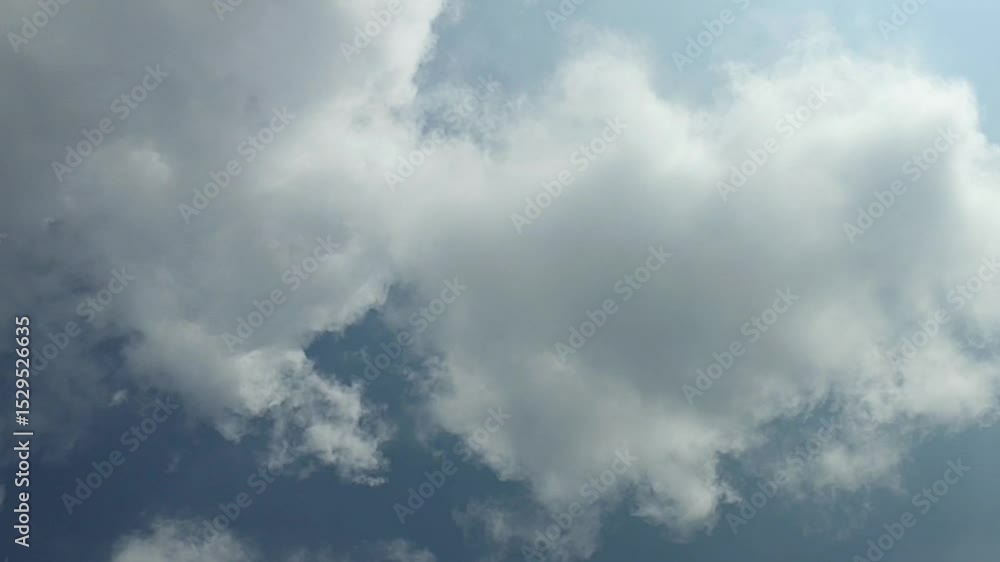 Fluffy white clouds slowly drift across the blue daytime sky. beautiful clouds moving. Airy snow-white clouds moved to the side. Fluffy white clouds slowly drift across the blue daytime sky. beautiful clouds moving. Airy snow-white clouds moved to the side.