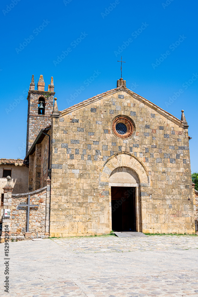 Fototapeta premium Historic Romanesque church in Monteriggioni, Tuscany, under a clear blue sky