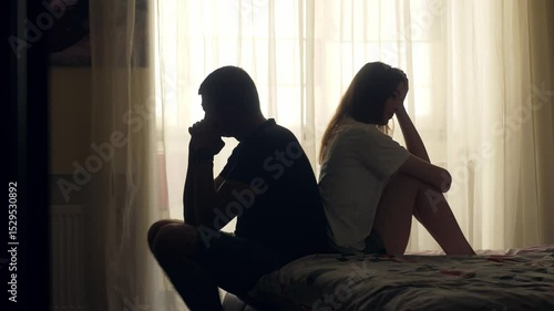 A couple sits together in silence, emotionally distant and disconnected. Despite physical closeness, tension and isolation dominate. A visual concept of relationship crisis and mental health.