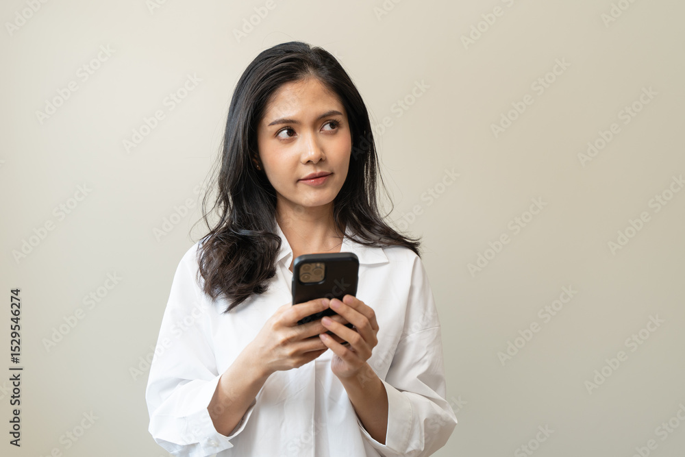 Anxiety Asian woman holding a smartphone and thinking about fake news in app. Anxiety Asian woman holding a smartphone and thinking about fake news in app.
