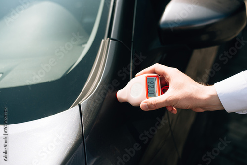Bilde på lerret Measuring thickness of the car paint coating with paint thickness gauge by profe
