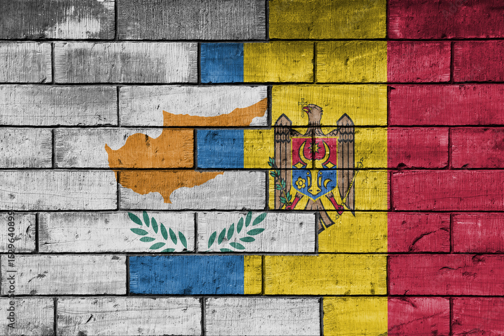 Fototapeta premium colourful painted big national flag of moldova and flag of cyprus on a massive old brick wall background. concept