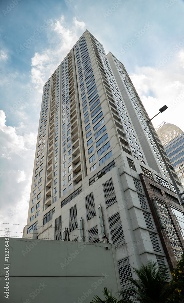 Obraz premium Architectural design of an office building in Jakarta. Photographed during the daytime sunny blue sky cloudy weather. 
