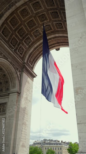 French flag under Arc de Triomphe with Haussmann view