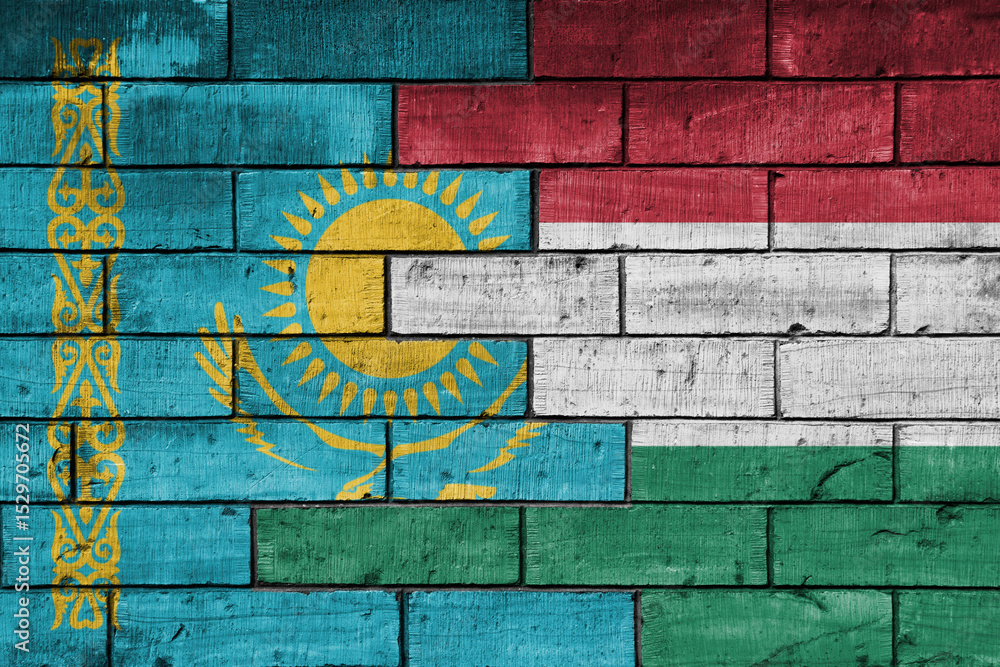 Naklejka premium colourful painted big national flag of hungary and flag of kazakhstan on a massive old brick wall background. concept