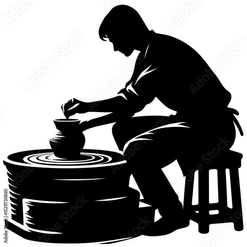 Young man shaping pottery on a wheel in a creative studio - Concept of Art and creativity  