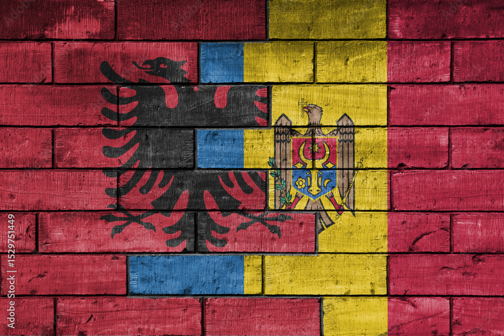 Fototapeta premium colourful painted big national flag of moldova and flag of albania on a massive old brick wall background. concept