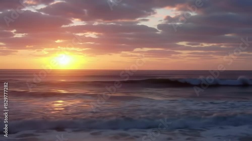Ocean Waves at Sunset with Pink Clouds and Golden Light Reflections on Water