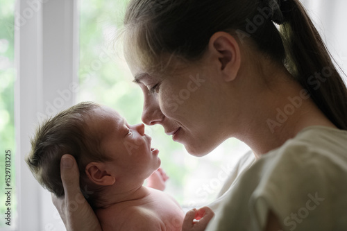 Tender Moment Between Mother and Newborn Baby