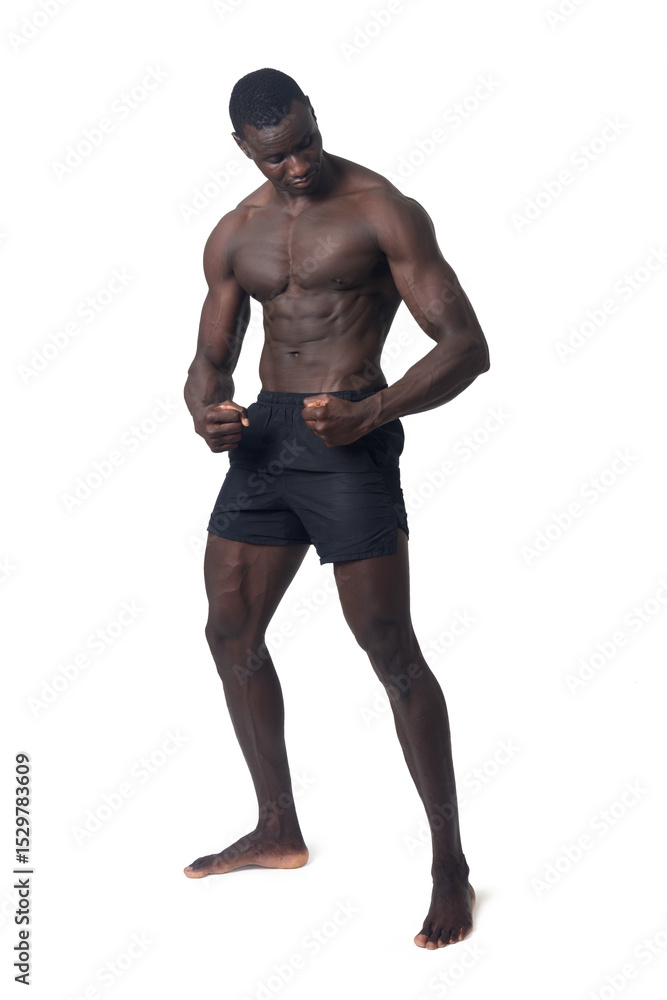 Full portrait of a man wearing shorts, barefoot, posing look down on a white background Full portrait of a man wearing shorts, barefoot, posing look down on a white background