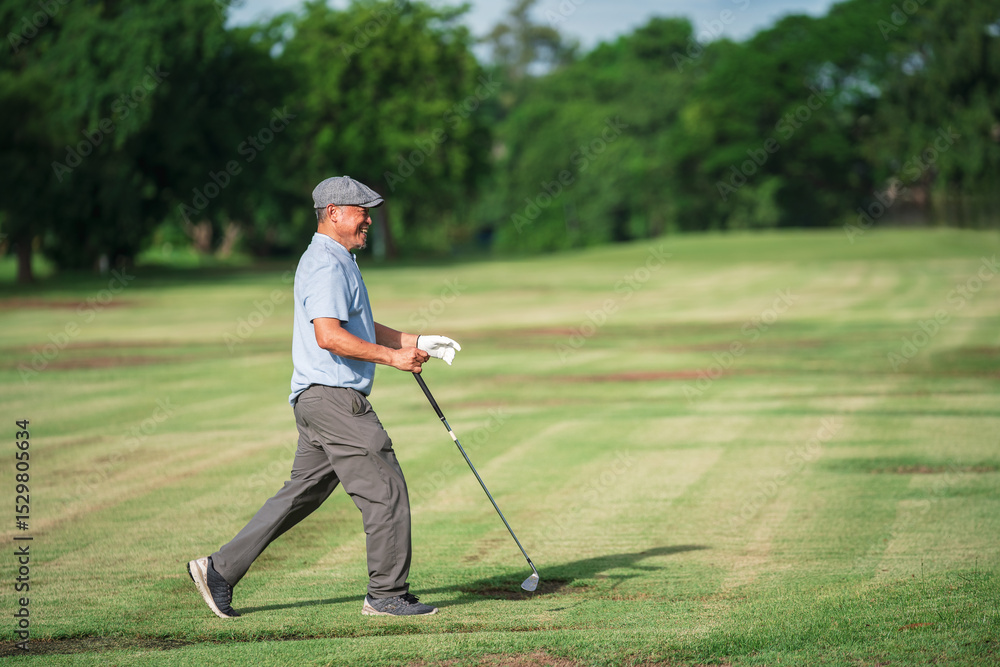 Retirement Lifestyle, Happy Asian senior man golfer walking on green fairway enjoying summer vacation and outdoor golf activity. Retirement Lifestyle, Happy Asian senior man golfer walking on green fairway enjoying summer vacation and outdoor golf activity.