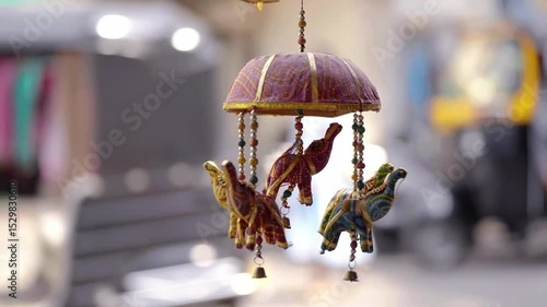 Rajasthani hanging decoration featuring miniature elephant figurines, small bells, and vibrant patterns, traditionally used as souvenirs or home decor items