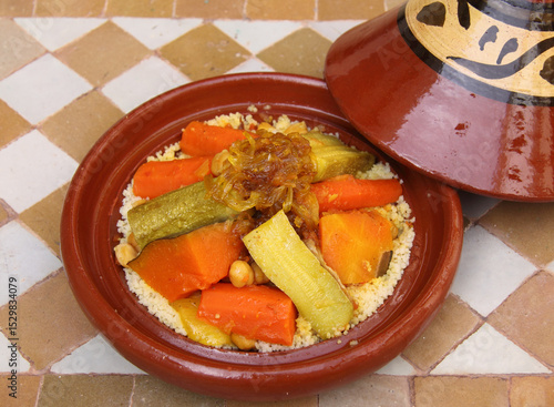 Tableau sur toile Morocco Traditional Berber tajine and couscous - Mixed vegetables, stewed beef with caramelized onions and saffron on a bed of couscous in a typical tajine dish