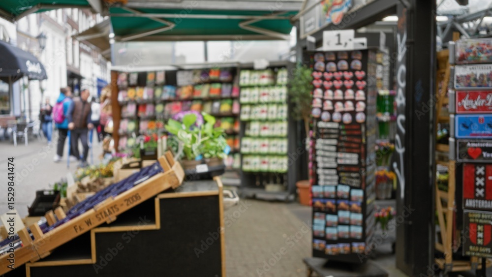Blurred scene of flower shop display with defocused people in background, showcasing vibrant floral arrangements and colorful merchandise in an outdoor market setting. Blurred scene of flower shop display with defocused people in background, showcasing vibrant floral arrangements and colorful merchandise in an outdoor market setting.