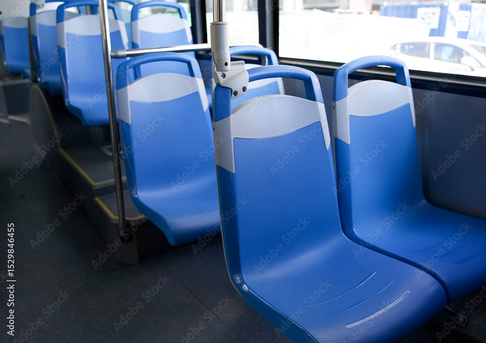 Fototapeta premium Blue plastic seats in modern public transport bus interior with clean lines and spacious design for commuters