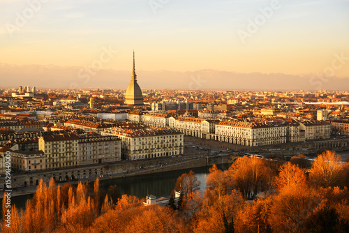 Fototapeta Naklejka Na Ścianę i Meble -  Evening view on the Turin city (Torino) during sunset. Mole Antonellia, Po river and Alps mountains on background. Piedmont, Italy