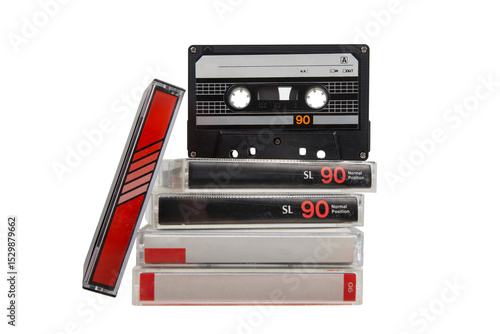 Canvas-taulu Stack of vintage audio cassette tapes with one black tape standing upright on to