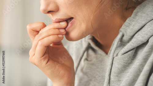 Quadro em tela Nervous young woman biting her nails
