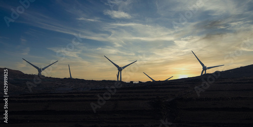 Landscape whit wind blade in the sunset cloud sky, removable energy concept.