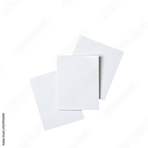 Blank white paper sheets arranged in an artistic manner on a dark background for creative design projects