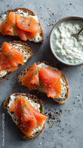 Delicious Smoked Salmon on Whole Grain Bread With Creamy Spread and Fresh Herbs