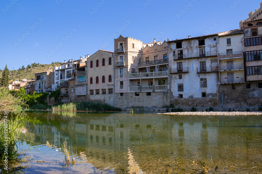 Fototapeta premium Panoramic view of Valderrobres, showing the ancient stone bridge, medieval architecture, and Santa María la Mayor Church.