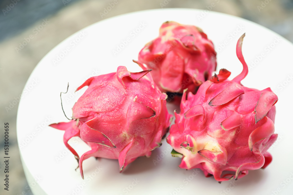 Delicious pitaya fruits on white table outdoors, closeup Delicious pitaya fruits on white table outdoors, closeup
