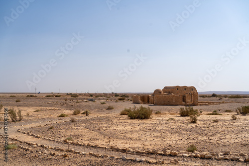 Deserted Ruins: Capturing the enduring allure of historical architecture, weathered stone ruins stand in stark contrast against a vast, arid landscape. A testament to a bygone era.