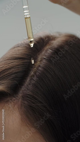 Serum dropper above hair parting