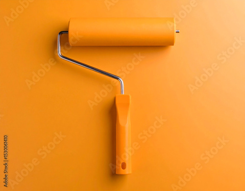 yellow paint roller on a wooden wall