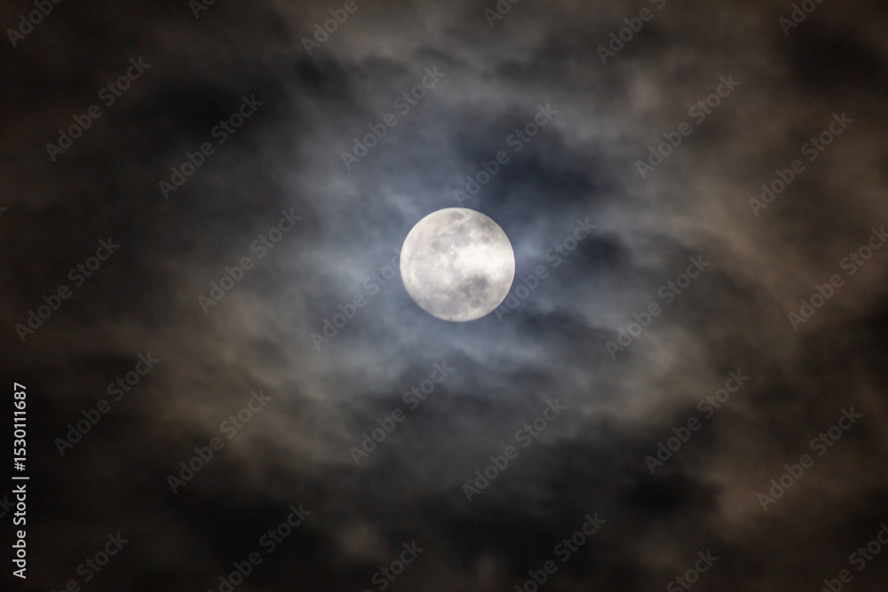 Full moon in the dark night sky with clouds Full moon in the dark night sky with clouds