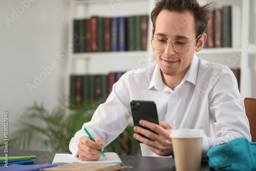 Male student with phone doi...
