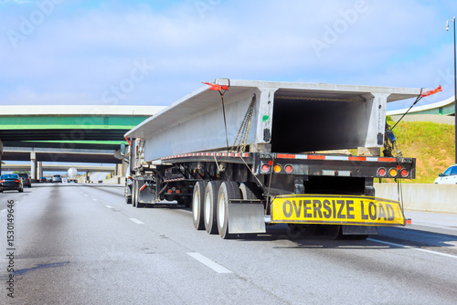 Canvas Print Large truck carrying oversize load concrete slabs on highway by overpasses