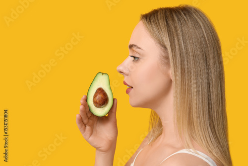 Young woman with avocado on...