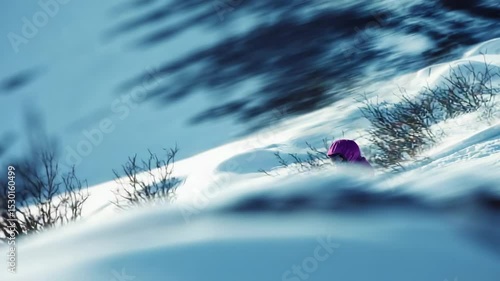 Child sledding down snowy hill