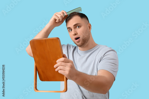 Shocked young man with hair...