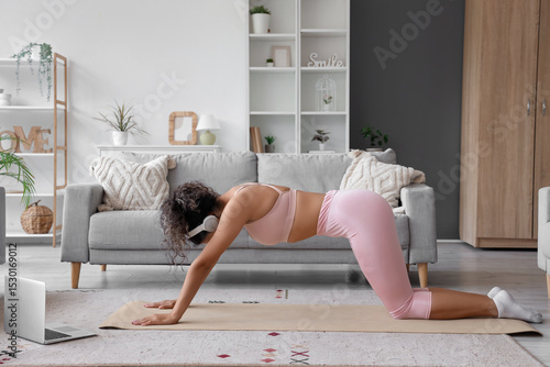 Young woman practicing yoga...