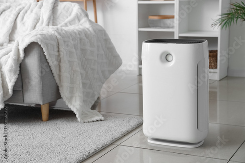 Modern air purifier on floo...