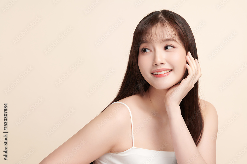 A beautiful young Asian woman with clean, fresh skin against a beige background. Skincare, facial treatment, cosmetology, beauty, and spa. An elegant portrait of an Asian woman. A beautiful young Asian woman with clean, fresh skin against a beige background. Skincare, facial treatment, cosmetology, beauty, and spa. An elegant portrait of an Asian woman.