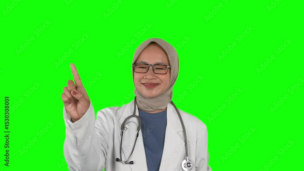 Confident Muslim Female Doctor Pointing Upward – Green Screen Background Confident Muslim Female Doctor Pointing Upward – Green Screen Background