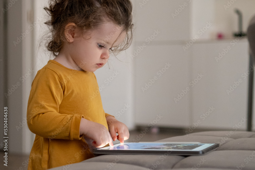 Child exploring creativity with a drawing app on a tablet in a modern living room environment. Child exploring creativity with a drawing app on a tablet in a modern living room environment.