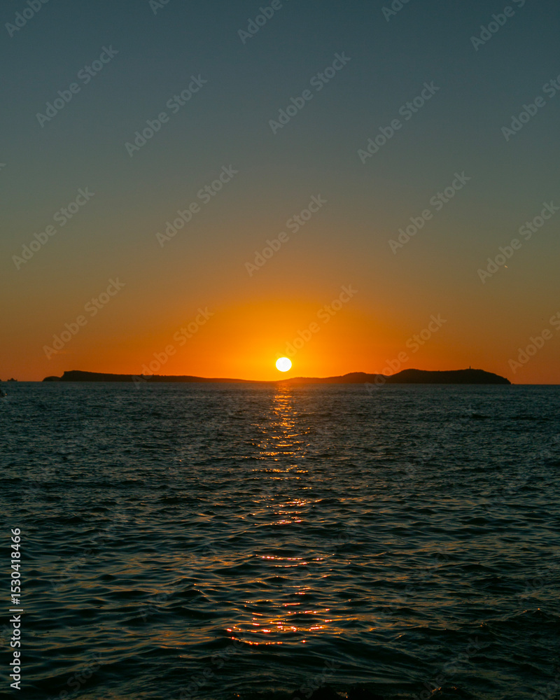 Fototapeta premium Beautiful sunset from Cafe Mambo in San Antonio Bay on the island of Ibiza in summer.