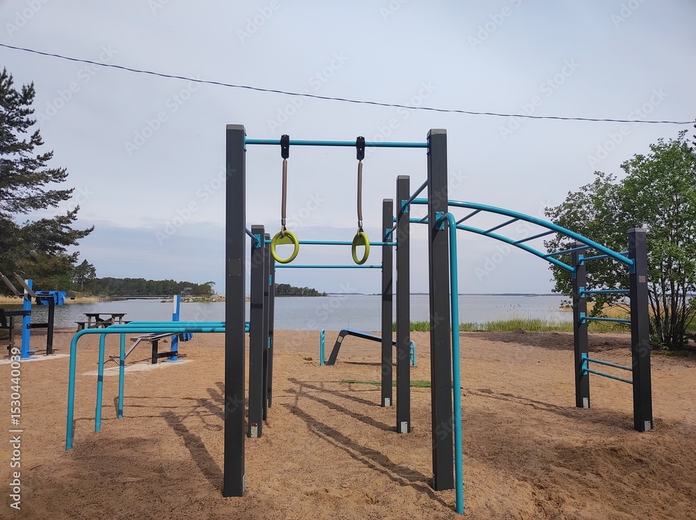 Fototapeta premium Sports ground on a sandy beach on the seashore, strength training equipment