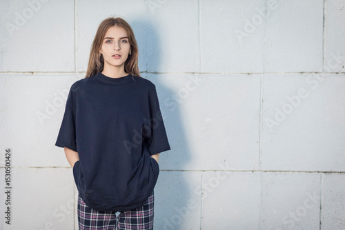 Cute Smiling Positive Winsome Caucasian Woman Wearing Black Shirt While Standing Posing At White Brick Wall Outdoors