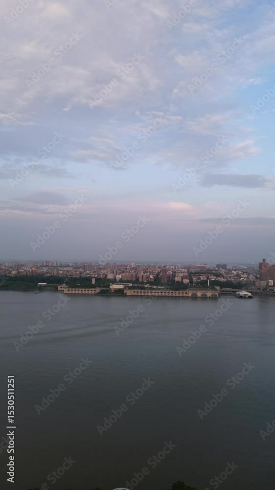 Drone sunset aerial over Fort Lee NJ showing the Hudson River and New York City skyline in warm evening light with clear skies and scenic city backdrop Drone sunset aerial over Fort Lee NJ showing the Hudson River and New York City skyline in warm evening light with clear skies and scenic city backdrop