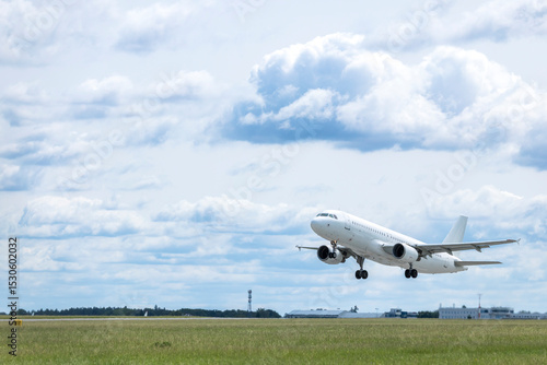 White passenger airplane taking off from Airport Prague, Czechia