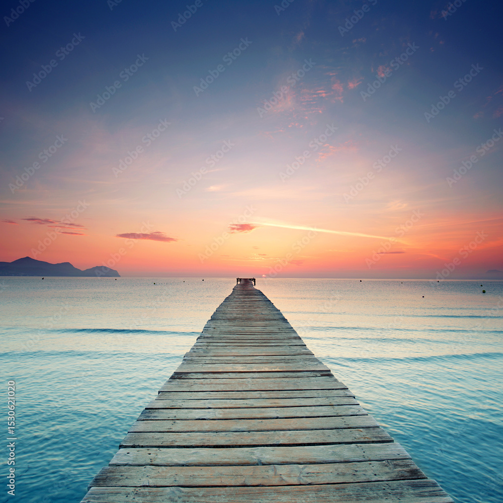 Fototapeta premium Endless Pier from wooden planks Over the Mediterranean, Glowing Under a Spectacular Summer Sunrise